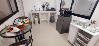 a small kitchen with a table and a microwave at Vistas increíbles desde San Blas 4 in Cusco