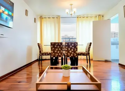a living room with a table and chairs at E Tourist Zone Wifi Pro 2 Smart TV 3B 1206 in Lima