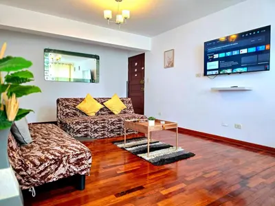 a living room with a couch and a table at E Tourist Zone Wifi Pro 2 Smart TV 3B 1206 in Lima