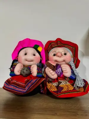 two figurines of two dolls sitting on a table at Aitanas House Huancaro in Cusco