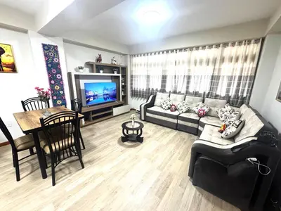 a living room with a couch and a table at Aitanas House Huancaro in Cusco