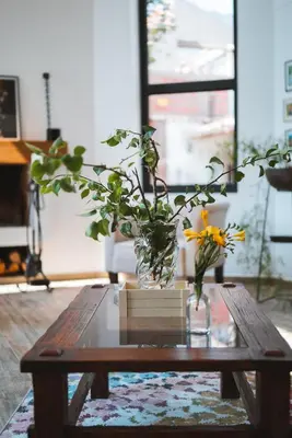 a vase with a yellow flower sitting on a coffee table at Casa Julia in Huayllabamba