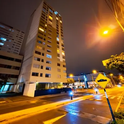 a city street at night with a tall building at E24h Modern Executive Loft 2BR 1401 in Lima