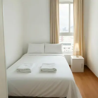 a white bed in a room with a window at E24h Modern Executive Loft 2BR 1401 in Lima