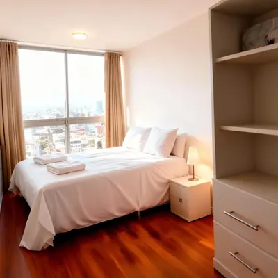 a bedroom with a white bed and a large window at E24h Modern Executive Loft 2BR 1401 in Lima