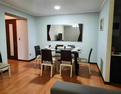 a dining room with a table and chairs and a mirror at E Green View Parking Wifi Pro 4B 904 in Lima