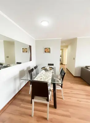 a dining room with a glass table and chairs at E Green View Parking Wifi Pro 4B 904 in Lima