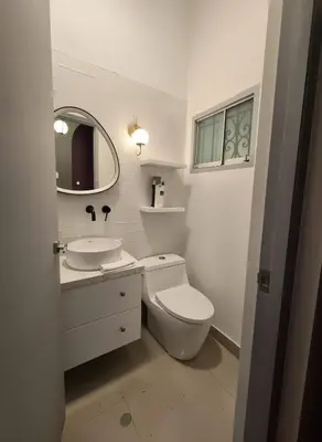 a bathroom with a toilet and a sink and a mirror at E LidiaHome Boutique Room Miraflores Wifi Pro 1B in Lima