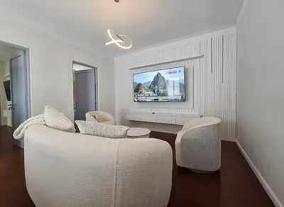 a living room with a white couch and a tv at E LidiaHome Boutique Room Miraflores Wifi Pro 1B in Lima