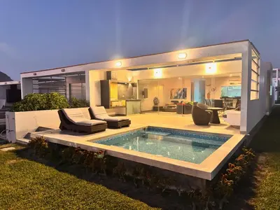 a house with a swimming pool in the backyard at Casa de playa 1era fila cala del mar in Salitre