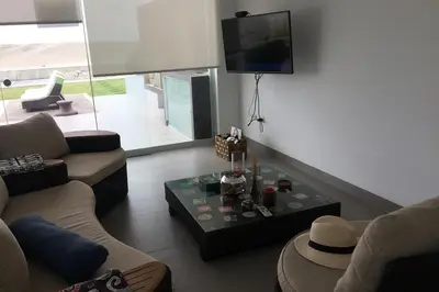 a living room with a couch and a table at Casa de playa 1era fila cala del mar in Salitre