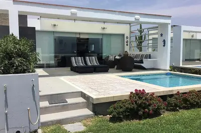 a house with a swimming pool in the backyard at Casa de playa 1era fila cala del mar in Salitre