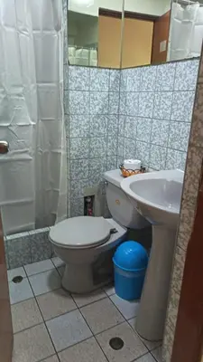 a bathroom with a toilet and a sink at Hostal Winya in Lima