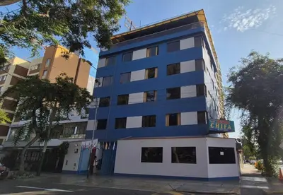 a blue and white building on a city street at Hostal Winya in Lima
