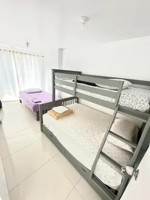 a bedroom with two bunk beds in a room at Casa playa Paracas-Pisco in Pisco