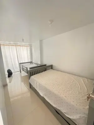 a white bedroom with a bed and a window at Casa playa Paracas-Pisco in Pisco