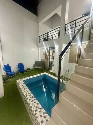 a swimming pool in the middle of a house at Casa playa Paracas-Pisco in Pisco