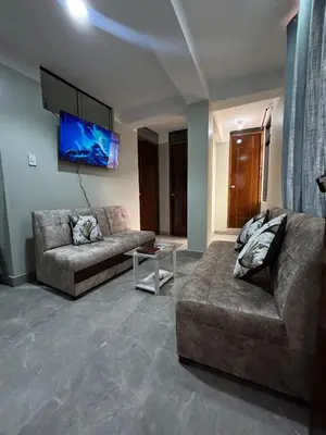 a living room with two couches and a flat screen tv at Hogar Mesco in Cusco