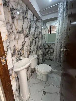 a bathroom with a toilet and a sink at Hogar Mesco in Cusco