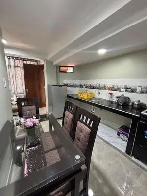 a kitchen with a table and chairs and a counter at Hogar Mesco in Cusco