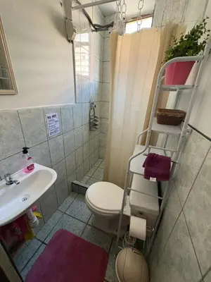 a small bathroom with a toilet and a sink at super cute affordable mini apt, san Blas in Cusco