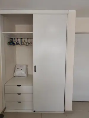 a closet with a white door and a drawer at La casa de Betty in Huancayo