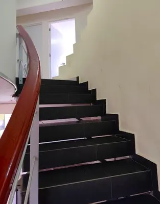 a staircase with black steps and a window at La casa de Betty in Huancayo