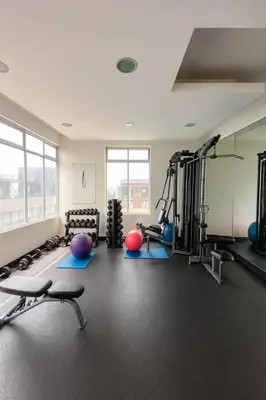 a gym with several treadmills and exercise machines at Dpto exclusivo en San Miguel con piscina y gym in Lima