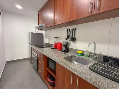 a kitchen with a sink and a counter top at Dpto exclusivo en San Miguel con piscina y gym in Lima