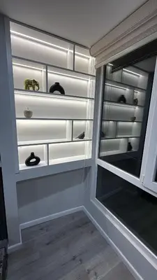 a closet with white shelves and a window at Modern and Cozy appartment in Lima