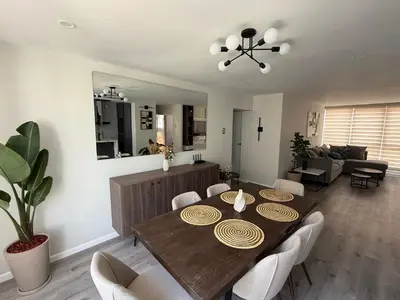 a living room with a wooden table and chairs at Modern and Cozy appartment in Lima