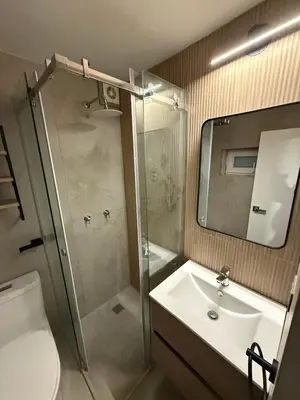a bathroom with a shower and a sink and a toilet at Modern and Cozy appartment in Lima
