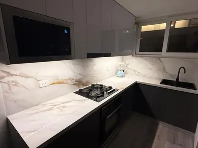 a kitchen with white marble counter tops and a stove at Modern and Cozy appartment in Lima