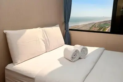 a bedroom with a bed with two towels on it at Perfect Balance Rest and Work Study Oceanfront in San Antonio
