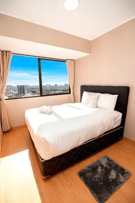 a bedroom with a large bed with a large window at Perfect Balance Rest and Work Study Oceanfront in San Antonio