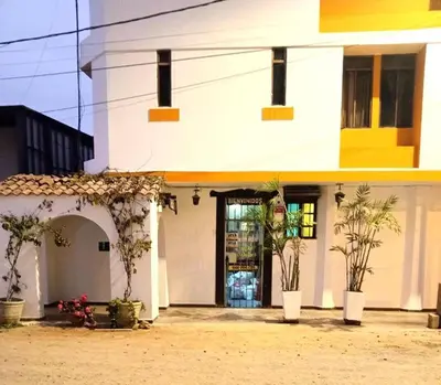 a white building with plants in front of it at Los Pulpos in Bombiso