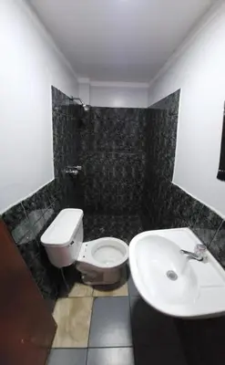 a bathroom with a toilet and a sink at Hostal Paris 3 Visita Lima con excelente ubicación, wifi gratis y vistas en in Lima