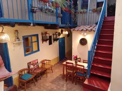 a staircase in a house with a table and chairs at Casa Margarita in Cusco