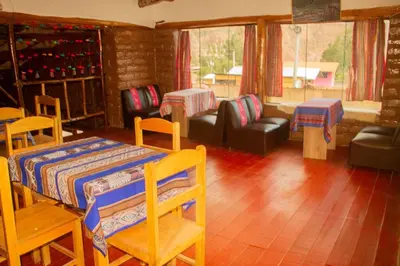 a living room with a table and chairs and a couch at Casa rústica Pumayalli in Urubamba