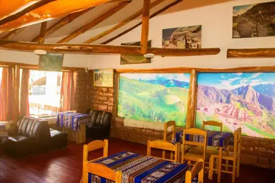 a room with a large painting on the wall at Casa rústica Pumayalli in Urubamba