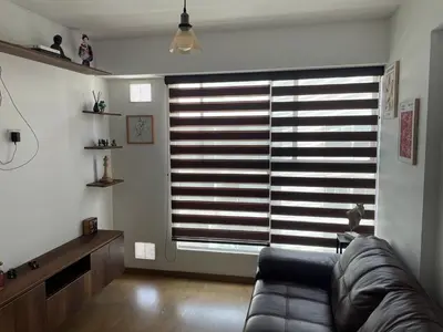 a living room with a couch and a large window at Lirios 2006 in Lima