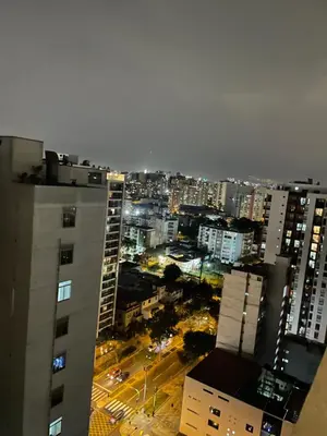 a view of a city at night with buildings at Lirios 2006 in Lima