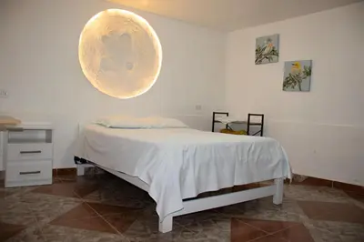 a bedroom with a bed with a large orb on the wall at Xaxa Lodge in Tarma