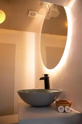 a bathroom with a bowl sink and a mirror at Xaxa Lodge in Tarma