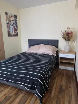 a bed with a black and white striped comforter in a bedroom at Barranco blue sea in Lima