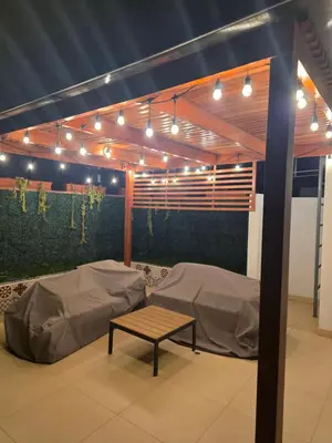 a room with two beds and a table and lights at Barranco blue sea in Lima
