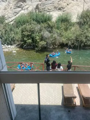 a group of people on a boat in a river at San Jerónimo River Lodge in Lunahuaná