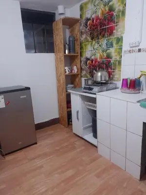 a kitchen with a sink and a stove top oven at Apartamento Salkantay con vista al Cusco in Cusco