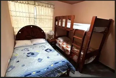 a bedroom with two bunk beds and a crib at Encanto azul Jardín, Parrilla y juegos in Santa Rosa
