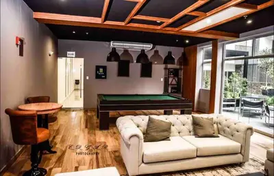 a living room with a couch and a pool table at Lovely Ocean View Apartment 1512 in Lima